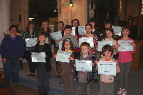 Sarah Benham with some of the swimmers and their completion certificates.