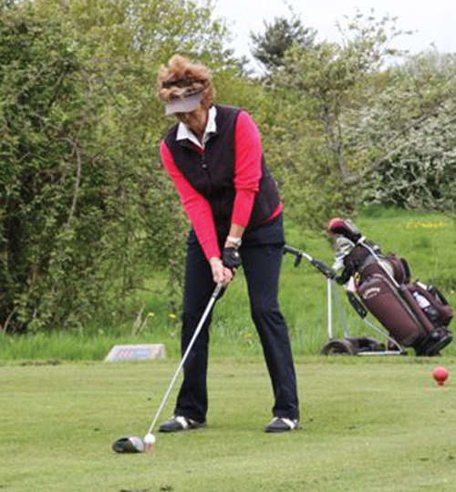 A lady golfer tees off at the Rotary Golf Day