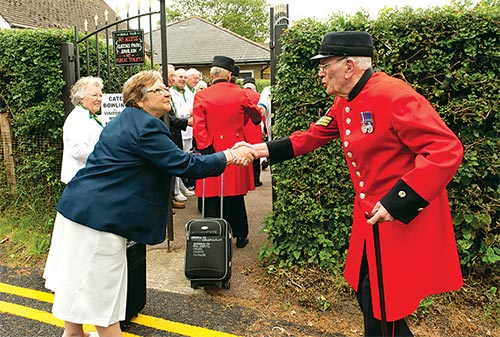 The Chelsea Pensioners arrive at Caterham Bowling Club. Photo by Emily McKay.