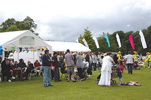 Crowds dodging the showers milled around by the refreshment tents.