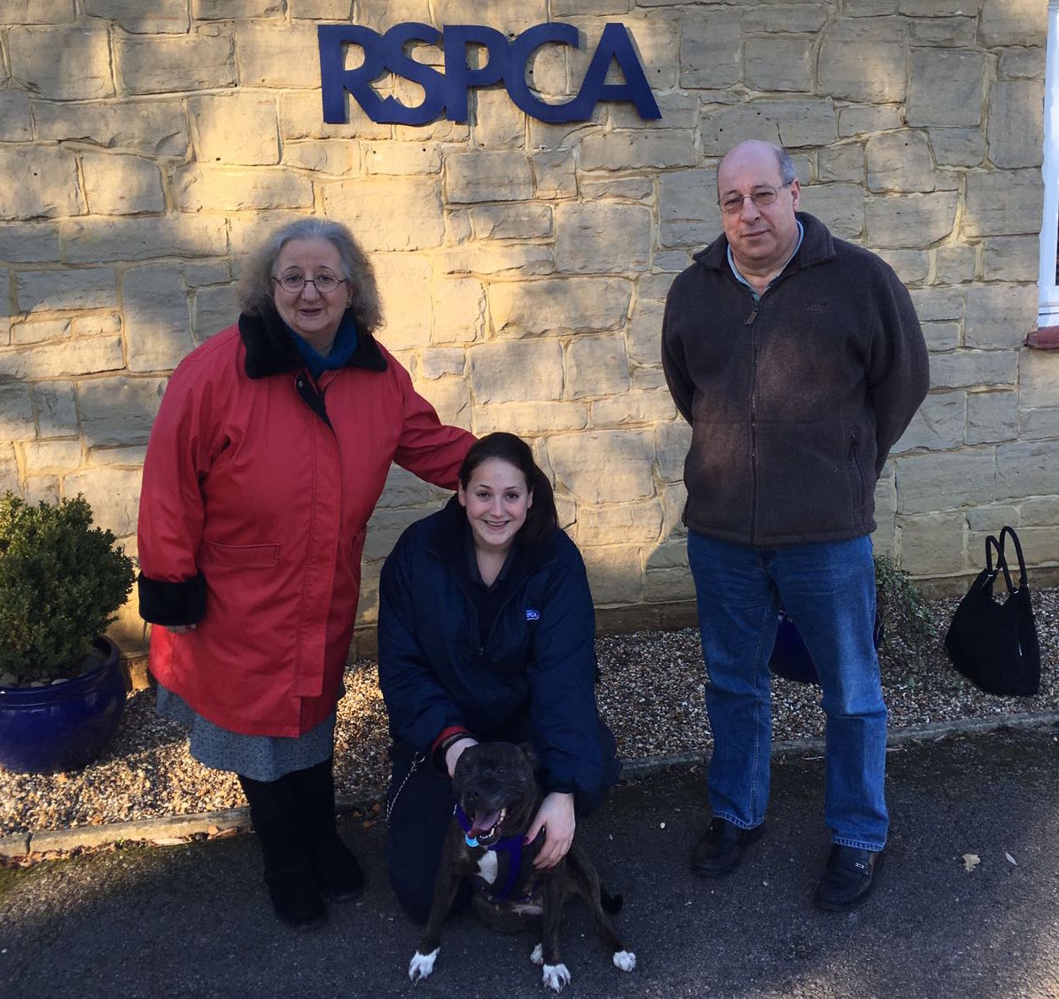 Celia and Paul Munro with RSPCA staff member, Hannah Hawkins  and Rosa the Staffordshire Bull Terrier.