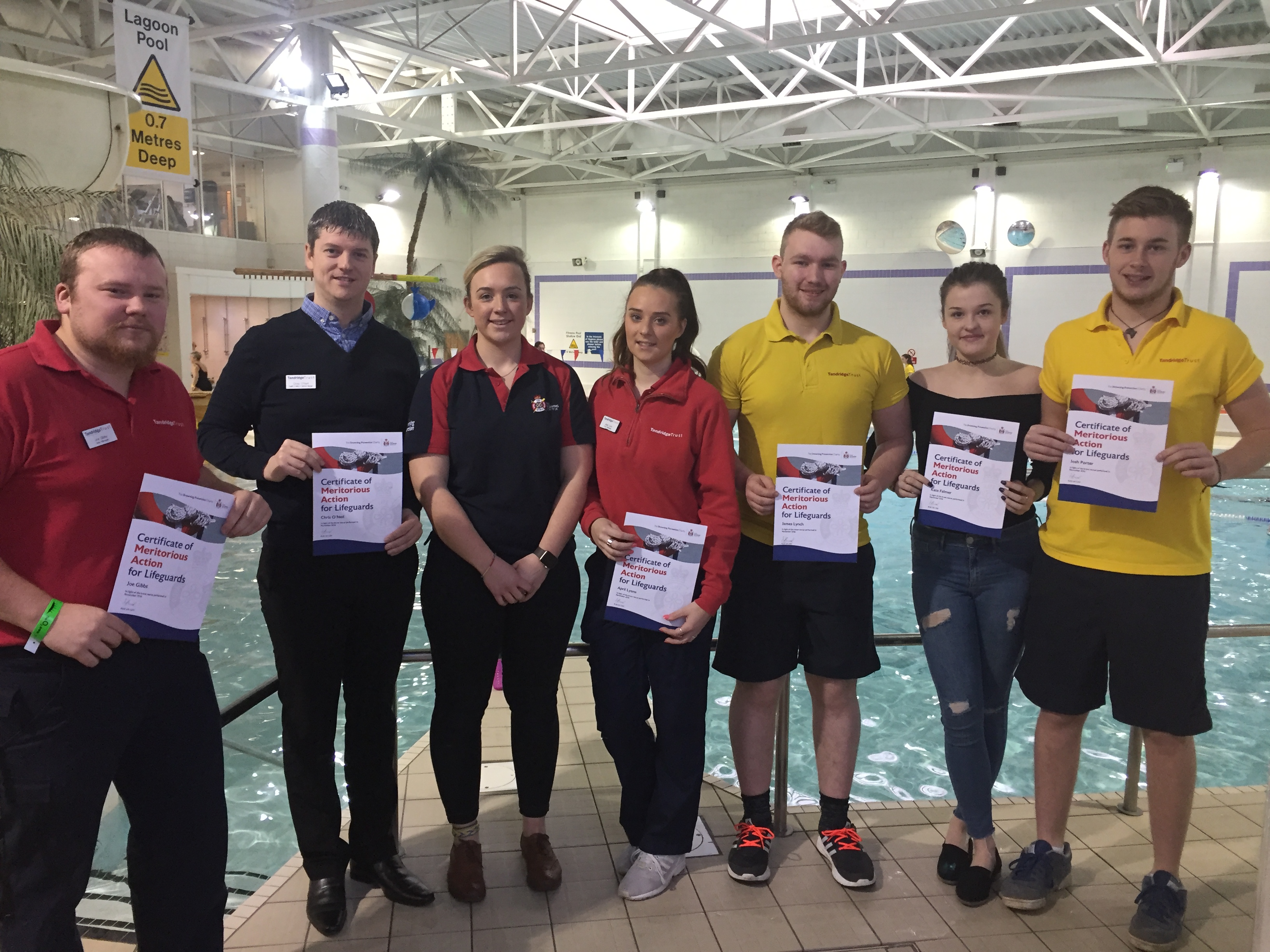 The Tandridge Leisure lifeguard team receiving their award from RLSS UK’s Helen Bowker. From left: Joe Gibbs, Chris O’Neill, RLSS UK Community Drowning Prevention Co-ordinator Helen Bowker, April Lyons, James Lynch, Kate Farmer and Josh Porter.